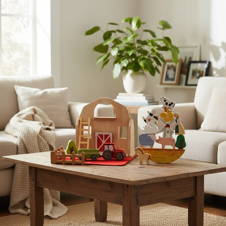 Wooden toys on a coffee table in a living room with a couch and plant in the background.