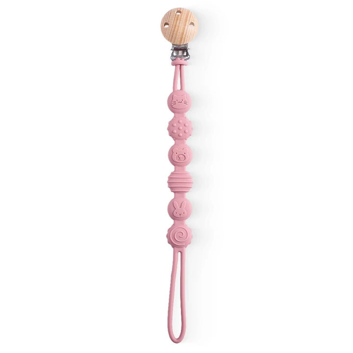 Pink baby teether with wooden handle on a white background