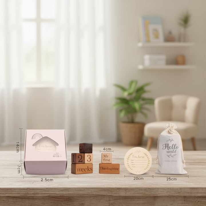 Baby-themed items including a box, blocks, and a bag on a wooden surface with a blurred background.