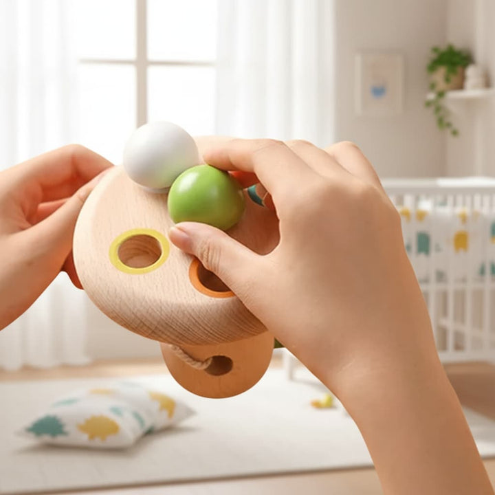 Child's hands playing with a wooden toy in a nursery setting