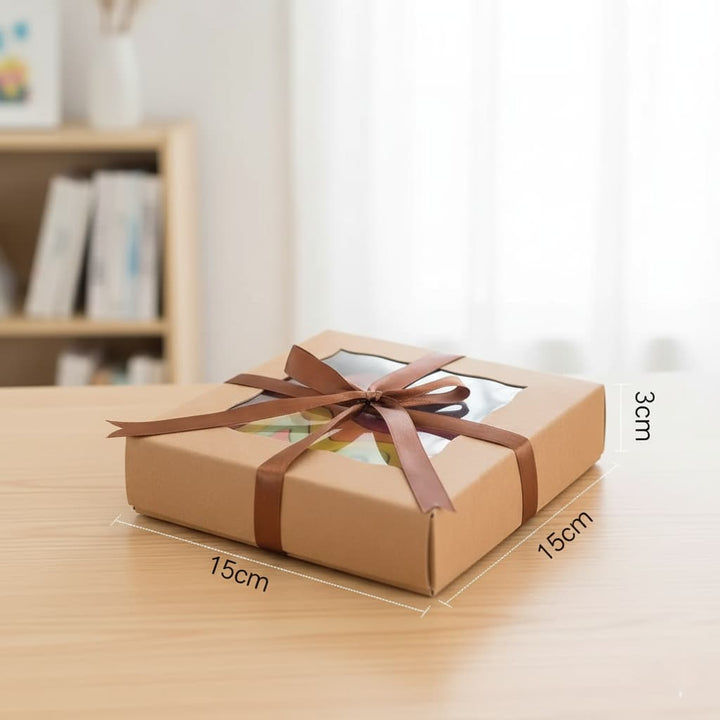 Brown gift box with a bow on a wooden surface, with measurements indicated.