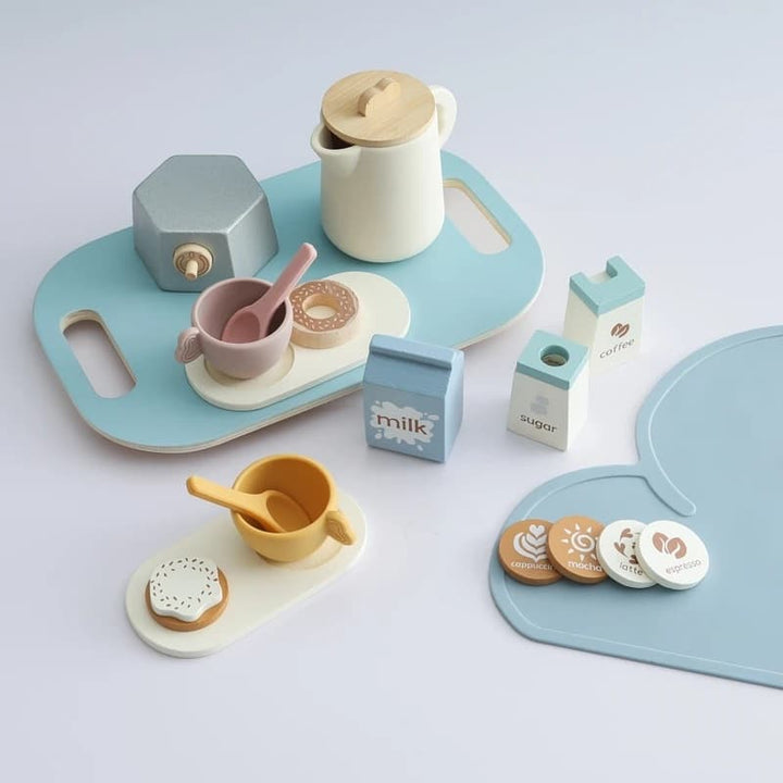 Children's toy tea set with pastel colors on a light gray background
