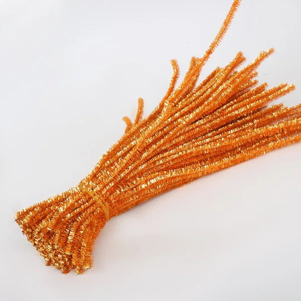 Bunch of orange pipe cleaners on a white background