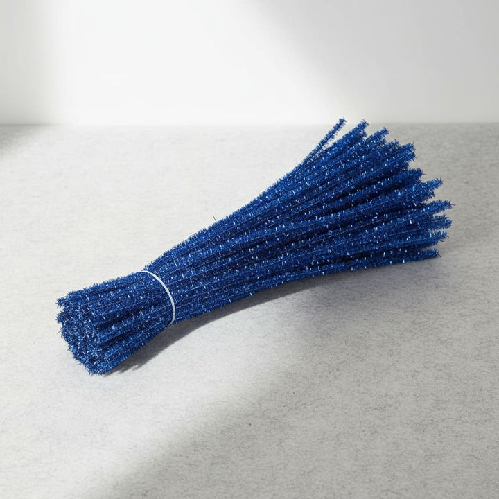 Bunch of blue pipe cleaners on a light gray background