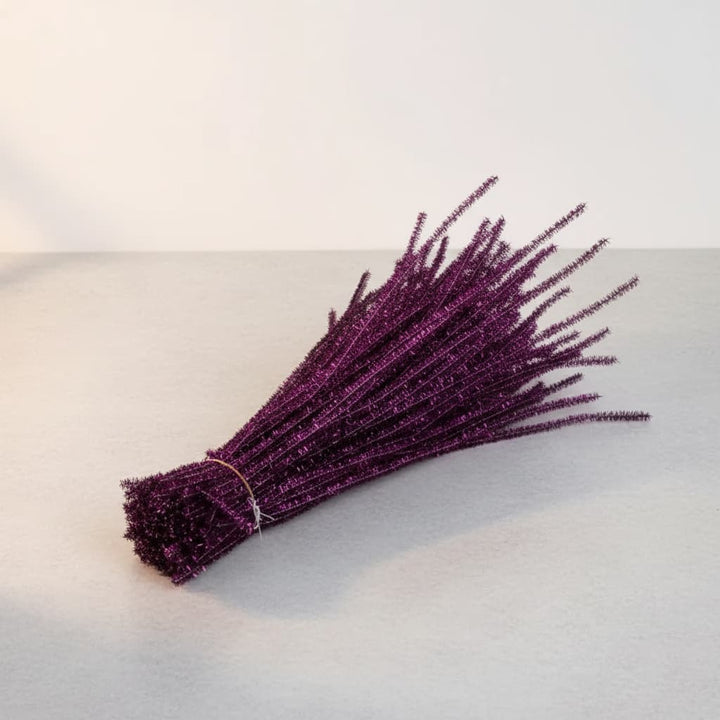Bunch of purple decorative fibers on a light gray surface