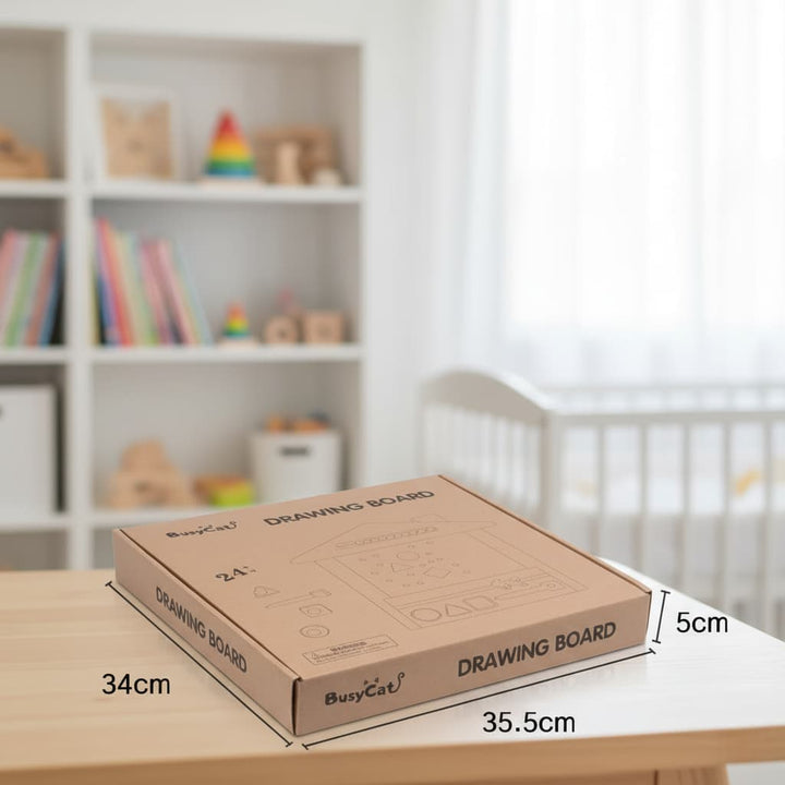 Cardboard drawing board with dimensions on a table in a room with shelves and toys.